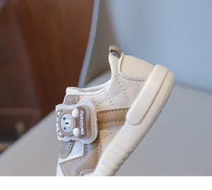 Detail of baby walking shoes with quilted leather and cute 3D bear velcro strap