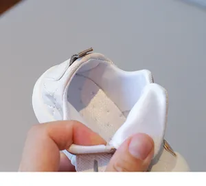 Detail shot of white baby walking shoes showing quilted faux leather and breathable mesh liner