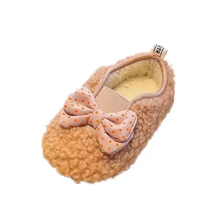 Plush baby girl fleece shoes with orange polka dot bow for winter warmth and comfort