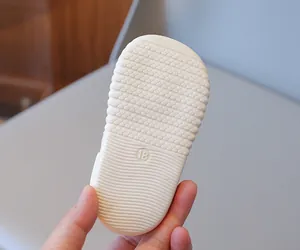 Detail view of baby walking shoe sole with anti-slip texture and size 18 marking