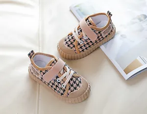 Detail view of toddler canvas shoes featuring houndstooth pattern and secure velcro strap