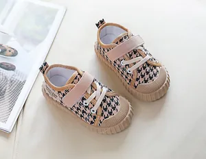 Detail of children's houndstooth canvas shoes with velcro strap and rubber toe cap