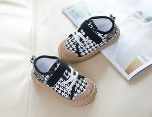 Detail view of houndstooth toddler canvas shoes with velcro strap and rubber toe cap
