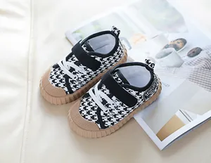 Detail of toddler canvas shoes with houndstooth pattern and non-slip rubber sole