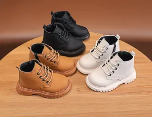 Three pairs of kids' martin boots in black, yellow, and beige with side zippers and non-slip soles