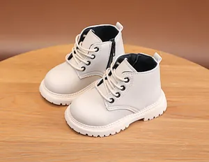 Detailed side view of off-white children boots with anti-slip thick rubber sole