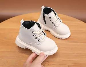 Detail of toddler cream leather boots with side zipper and sturdy non-slip white rubber sole