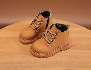 Detail view of khaki kids Martin boots featuring side zipper and non-slip rubber soles