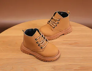 Detail of light brown children boots showing lace-up front and side zipper for easy wear