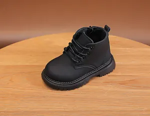 Detail of kids black matte leather boots with side zipper and non-slip rubber sole