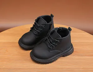 Detail of children's black boots showing side zipper, lace-up front and non-slip rubber sole