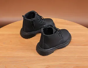 Detail view of children black martin boots with side zipper and thick anti-slip rubber sole