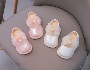 Detail of pink and white toddler princess shoes with large mesh bows and pearl beads