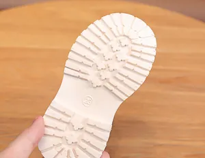 Detailed view of size 23 anti-slip rubber sole with deep grip for kids boots