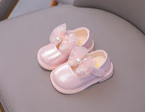 Macro detail of toddler Mary Jane shoe featuring mesh bow, pearls and pink sequins
