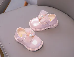 Detailed close-up of pink Mary Jane girls' shoes featuring mesh bows and pearl beads