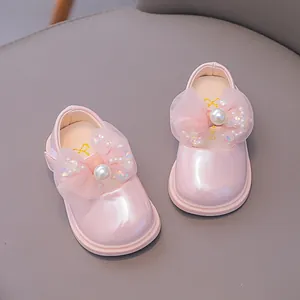 Pink Mary Jane shoes for toddler girls with glossy finish and pearl bow decoration