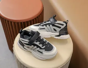 Detail of children's glowing athletic shoes featuring breathable mesh and velcro straps