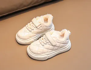 Close-up of beige quilted children winter shoes with warm faux fur lining and velcro strap