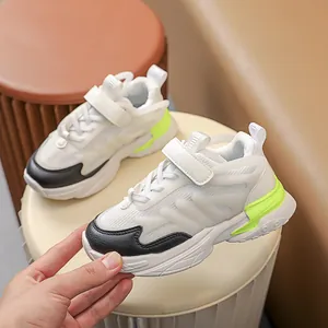 Detail of children's glowing chunky sneakers with mesh upper and hook-and-loop closure