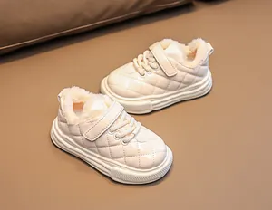 Detail of warm kids' winter shoes featuring quilted leather and thick faux fur lining