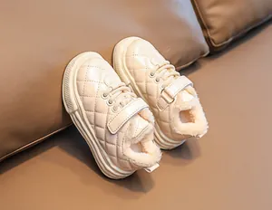Detail of cream toddler boots with quilted patent leather and warm faux fur lining