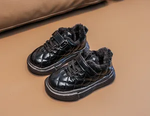 Detail of children's winter boots with glossy black finish and thick fleece lining
