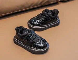 Close-up of quilted black patent leather kids boots with thick plush lining
