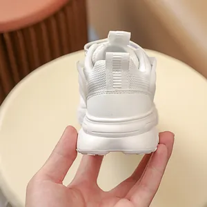 Close-up of kids white chunky sneaker heel with breathable mesh and pull tab detail