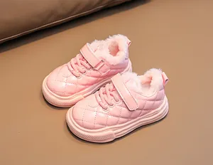 Close-up of pink quilted leather kids shoes with warm faux fur lining and velcro strap