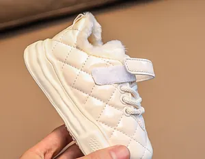 Detail of warm beige kids winter shoe featuring quilted pattern and thick plush lining