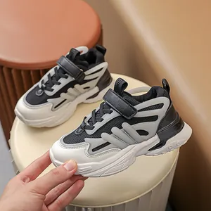 Kids luminous sneakers in black, white, and grey with breathable mesh and velcro straps