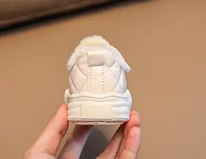 Detail of warm winter children shoes with thick faux fur lining and non-slip rubber sole