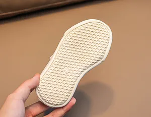 Detail of baby walking shoe sole with diamond anti-slip pattern and size 23 mark