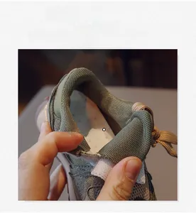 Detail of children's retro sneakers featuring breathable mesh lining and elastic laces