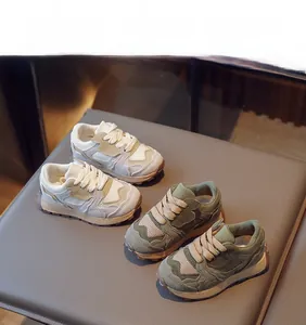 Close-up of stylish kids' retro sneakers featuring breathable mesh and anti-slip soles