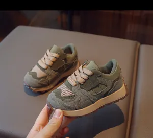 Detail of retro kids' sneaker featuring olive green patchwork and thick anti-slip sole