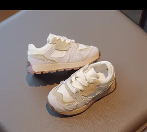 Macro view of retro kids sneakers featuring grey suede and caramel rubber traction sole