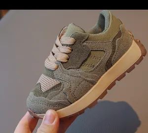 Close-up of kids' retro sneakers with mesh suede upper and textured rubber outsole