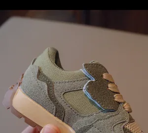 Detailed view of kids retro sneakers featuring olive suede texture and durable rubber sole