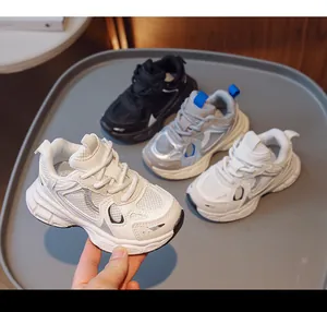 Detailed view of breathable mesh kids sneakers in white, black and grey blue colors