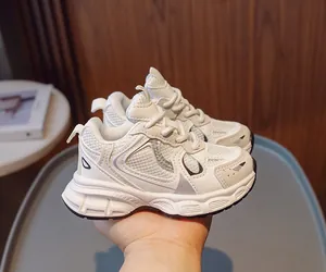 Detailed macro view of breathable mesh and synthetic leather on white kids' sneakers