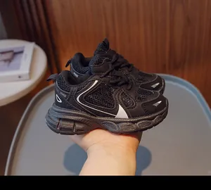 Detail of children's breathable black mesh running sneakers with non-slip thick soles