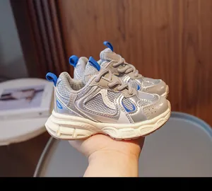 Detail of kids breathable mesh sports sneakers with silver leather and blue accents