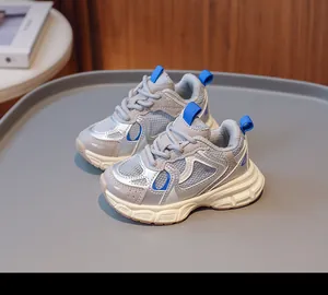 Close-up of breathable grey mesh fabric and blue accents on these kids sneakers