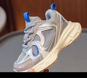 Detail of breathable mesh and silver synthetic leather on children sneaker with thick sole