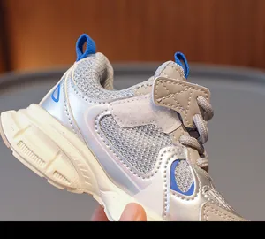 Detail view of children's breathable mesh sneakers with silver finish and velcro strap