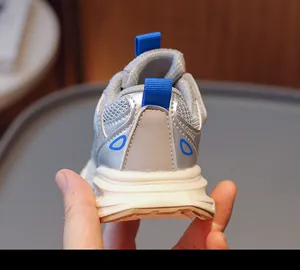 Detail view of children running shoes featuring padded silver heel and blue pull tab