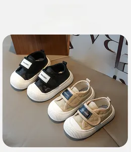 Detail view of toddler sneakers featuring diamond quilting and velcro straps in beige and black