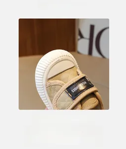 Detailed close-up of children's non-slip sneakers featuring a wide rubber toe and velcro closure